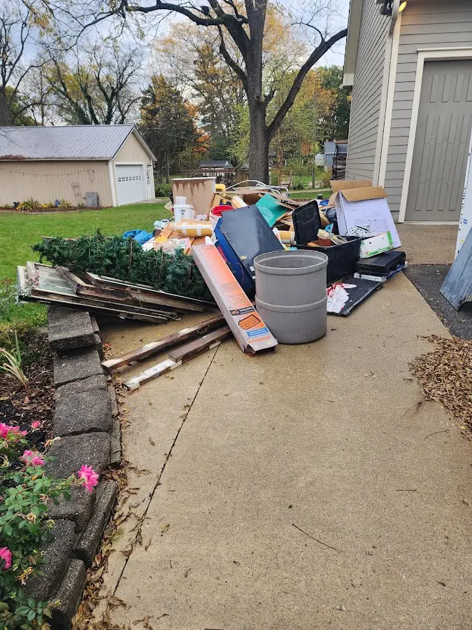 Dumpster being loaded with debris for 12 Yard Dumpster Rental in Shelley